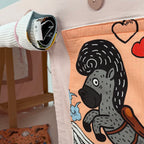 Close-up of fabric panel with a horse illustration attached to a table tent, with a rolled-up flap attached on the side